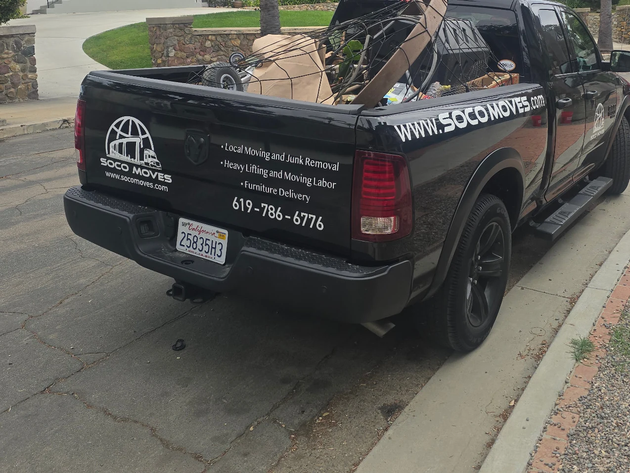 A branded Soco Moves pickup carrying secured unwanted household items.